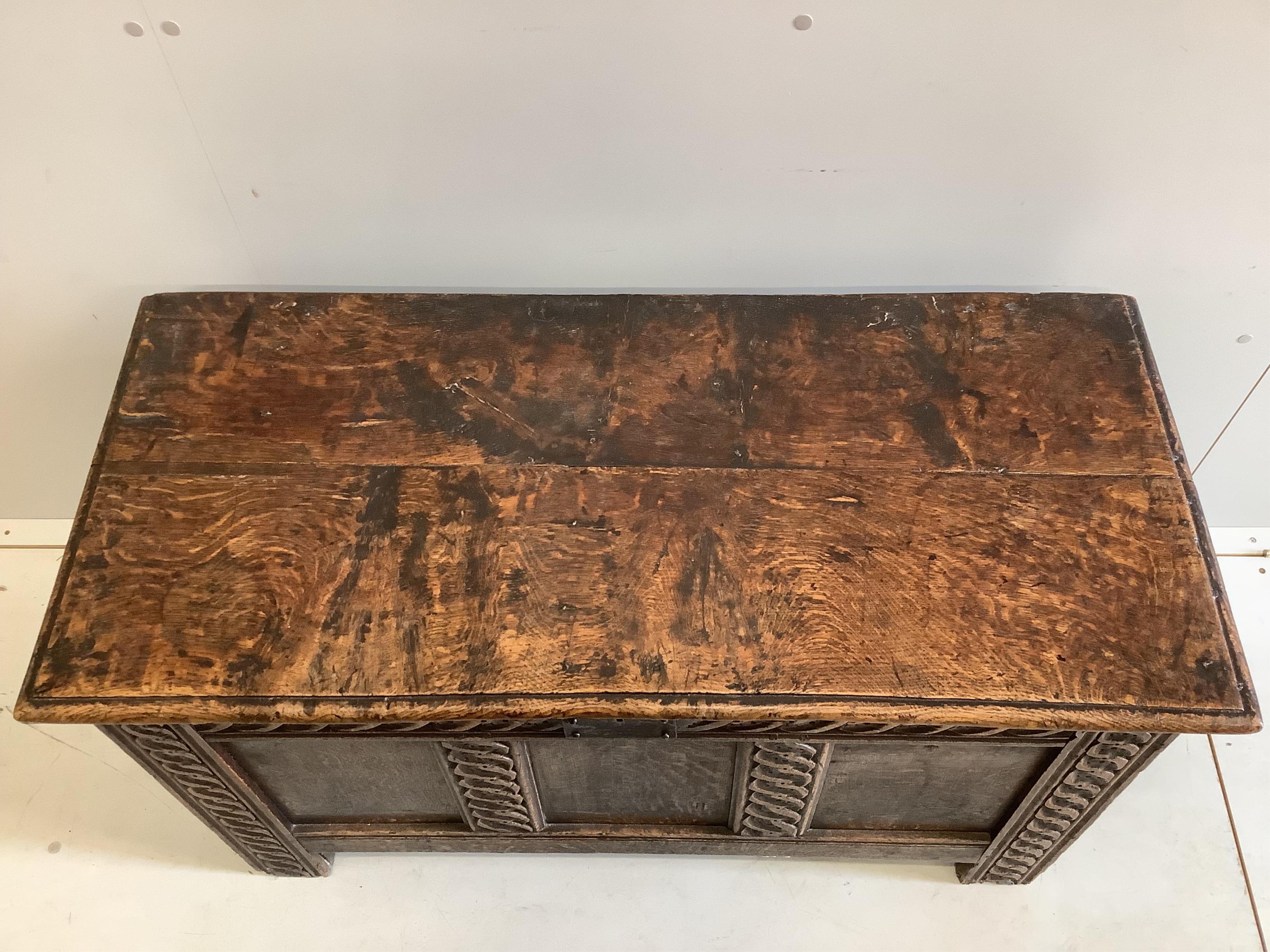 A 17th century panelled oak coffer, width 106cm, depth 48cm, height 61cm. Condition - fair